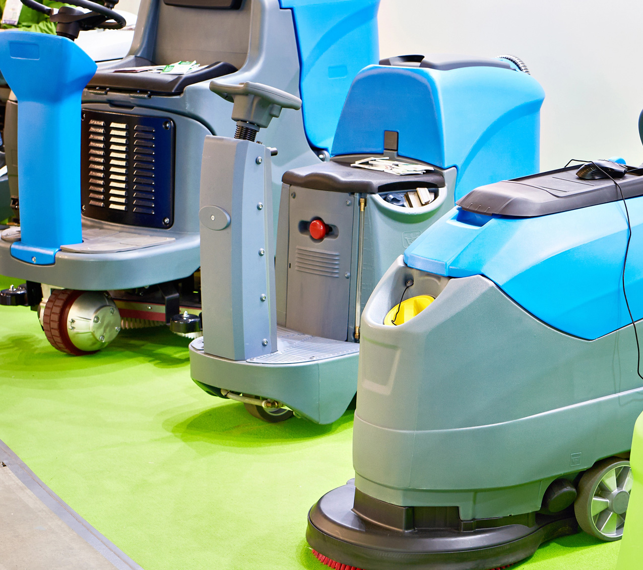 Commercial ride-on sweepers lined up